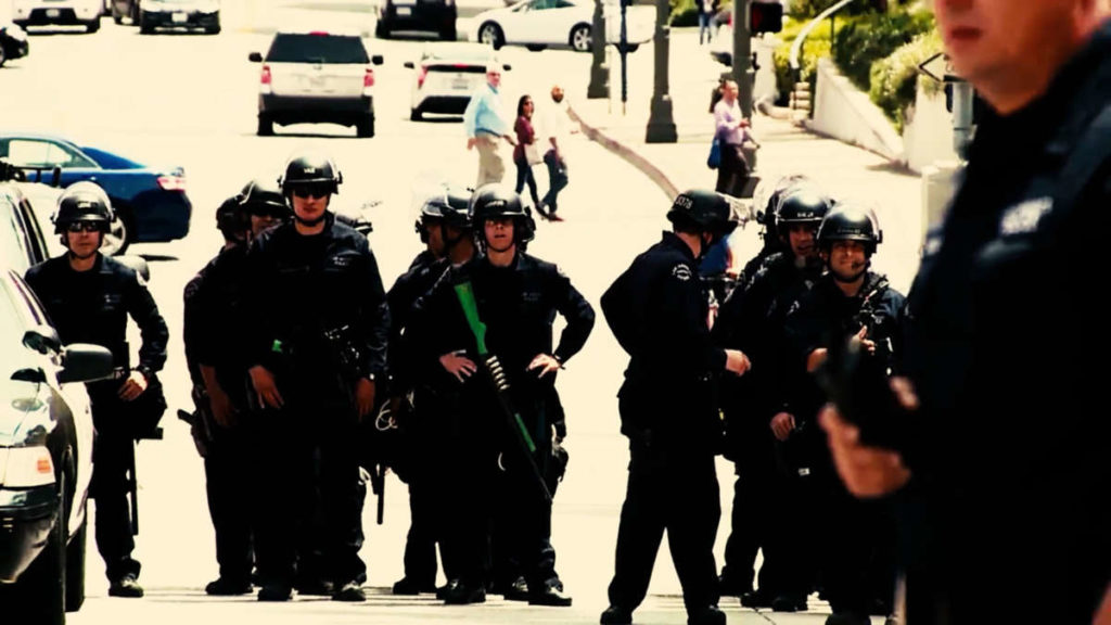 Police officers observing something in the streets