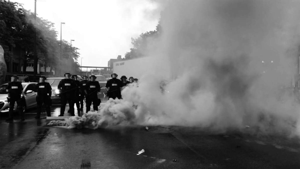 Police group on the streets with smoke
