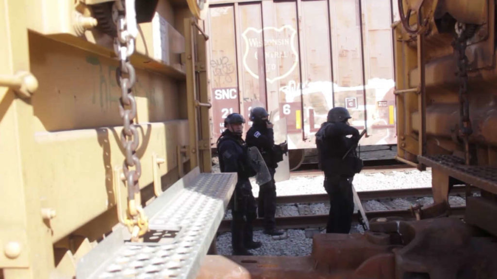 Police Officers behind a train